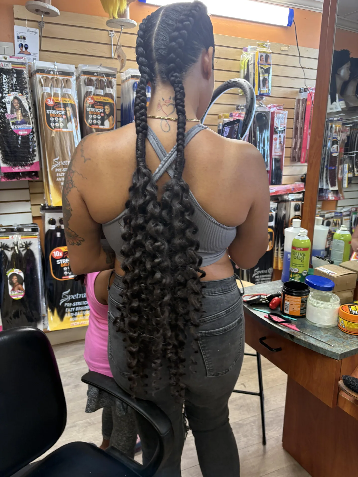 Long Braided Ponytail hairstyle by New Look Hair Salon in Attleboro MA